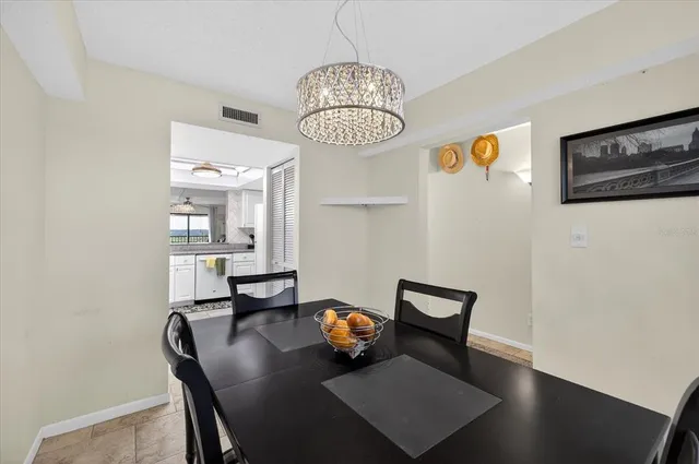 a kitchen with a refrigerator a stove and a sink with wooden floor