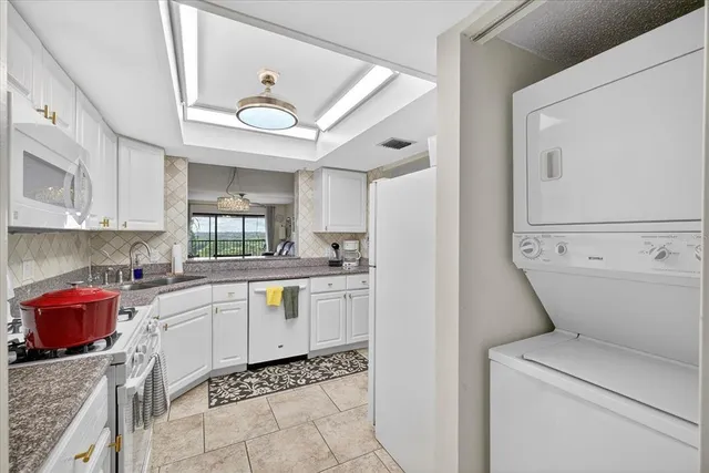 a living room with furniture a flat screen tv and a large window