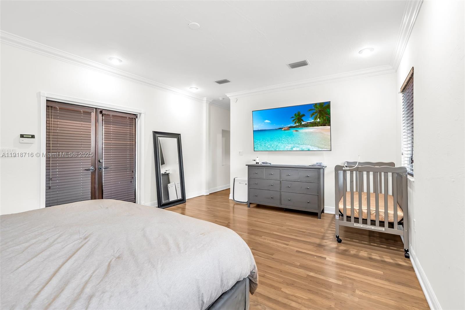 6376 Southwest 15th Street, Unit 6376 West Miami, FL 33155 - Photo 12 of 23 a bedroom with a bed and a flat screen tv