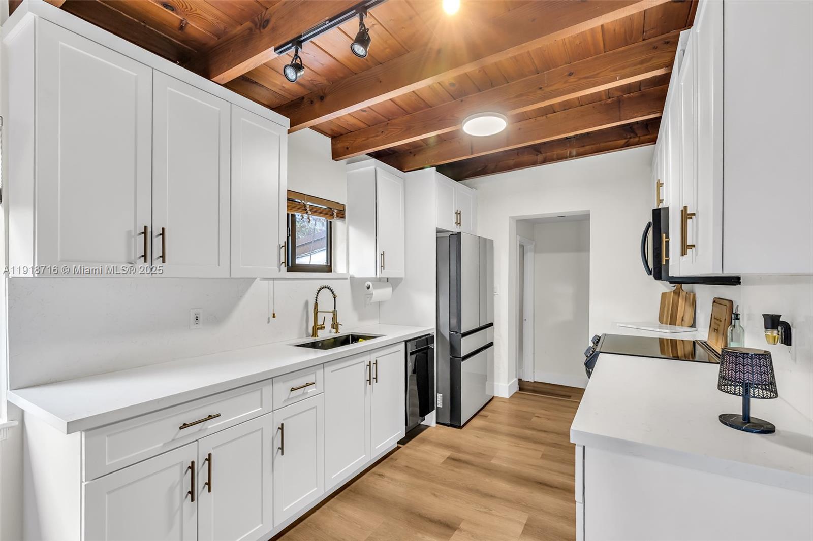 6376 Southwest 15th Street, Unit 6376 West Miami, FL 33155 - Photo 17 of 23 a kitchen with a sink appliances and cabinets