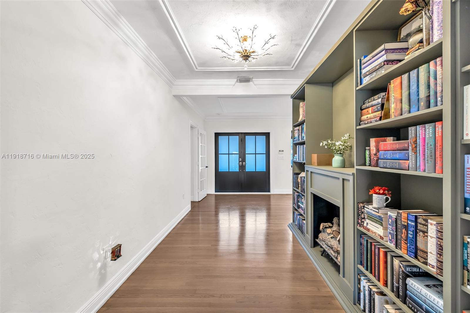 6376 Southwest 15th Street, Unit 6376 West Miami, FL 33155 - Photo 6 of 23 a living room with a book shelf and a fireplace