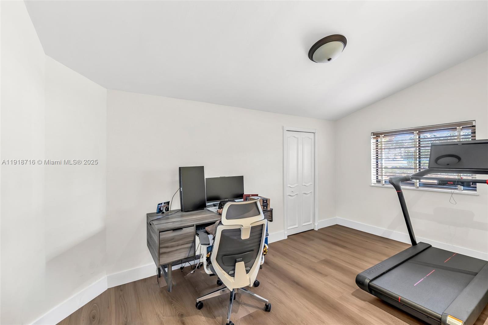 6376 Southwest 15th Street, Unit 6376 West Miami, FL 33155 - Photo 7 of 23 a view of a workspace with furniture and wooden floor