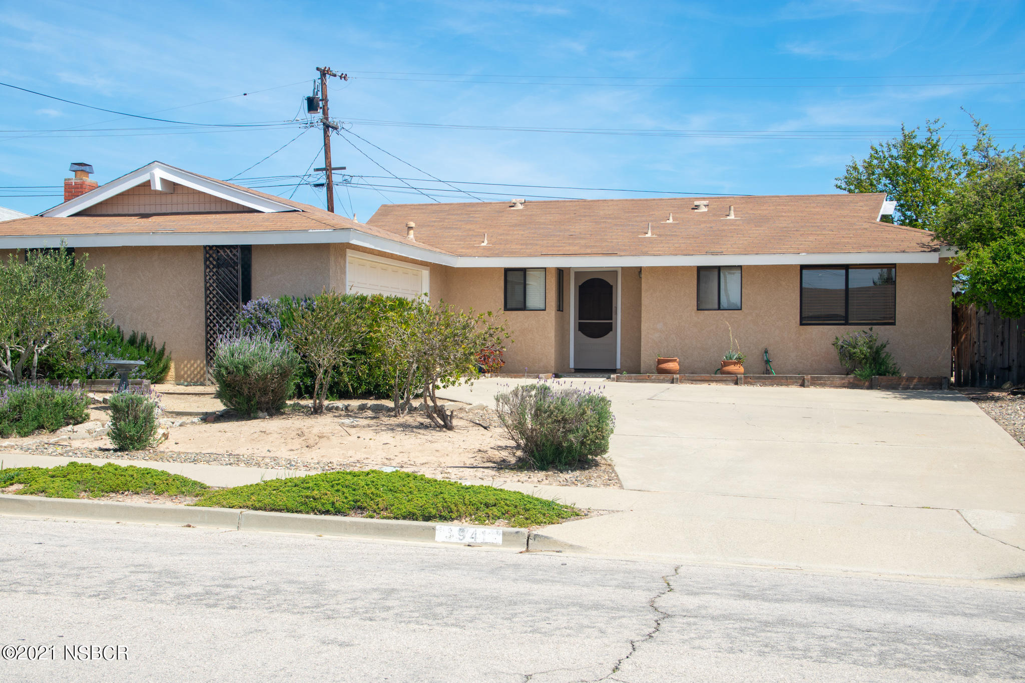 3941 Spica Way Lompoc, CA 93436 - Photo 1 of 24 a front view of a house with a yard and potted plants