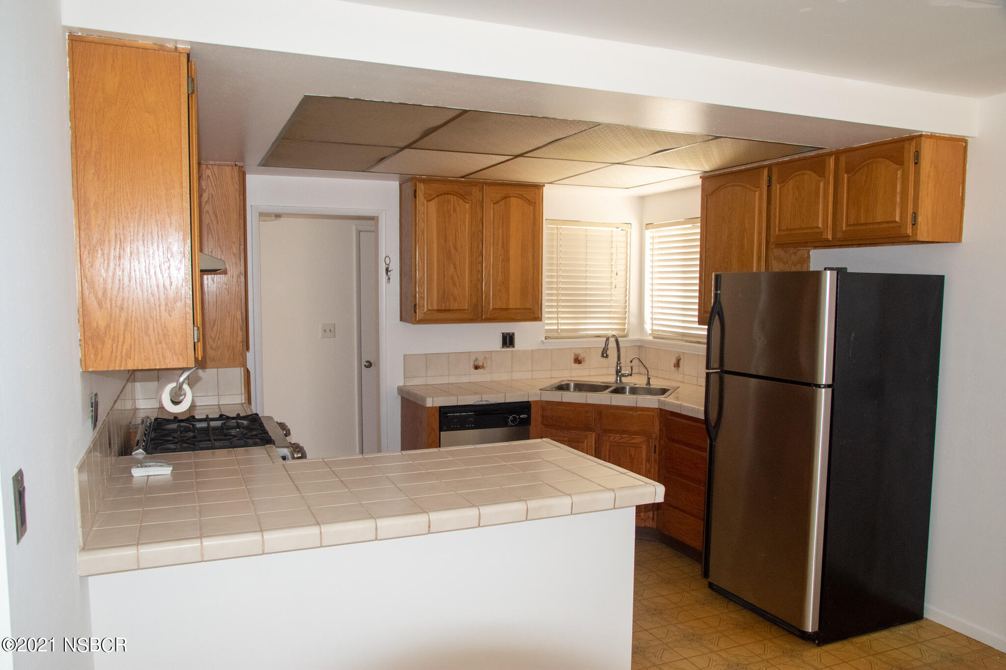 3941 Spica Way Lompoc, CA 93436 - Photo 2 of 24 a kitchen with a refrigerator and a sink