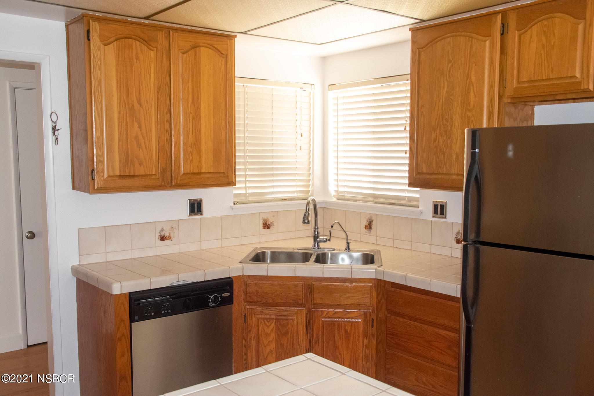 3941 Spica Way Lompoc, CA 93436 - Photo 3 of 24 a kitchen with a sink and a refrigerator