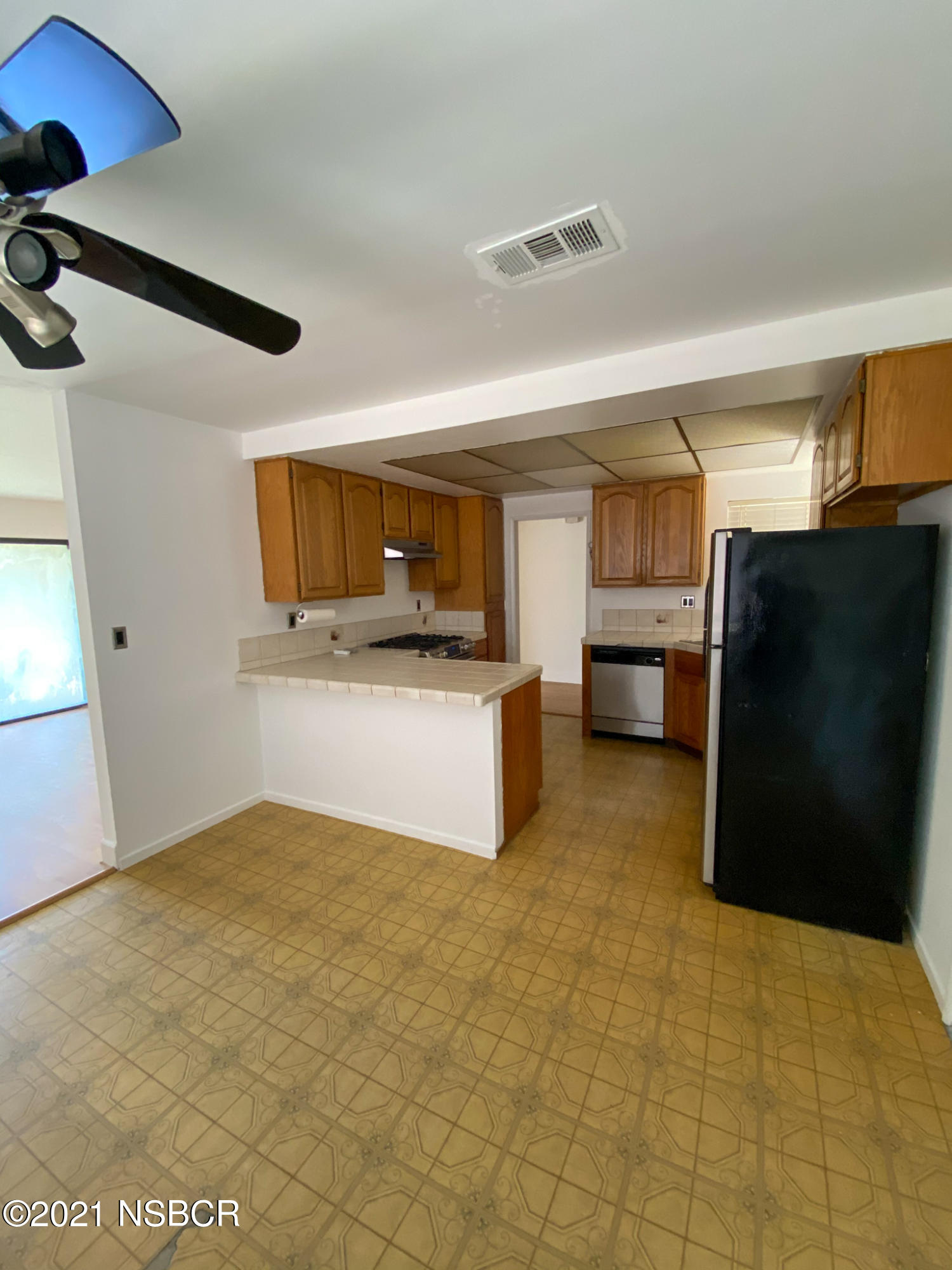 3941 Spica Way Lompoc, CA 93436 - Photo 9 of 24 a view of kitchen with refrigerator stove microwave and cabinets