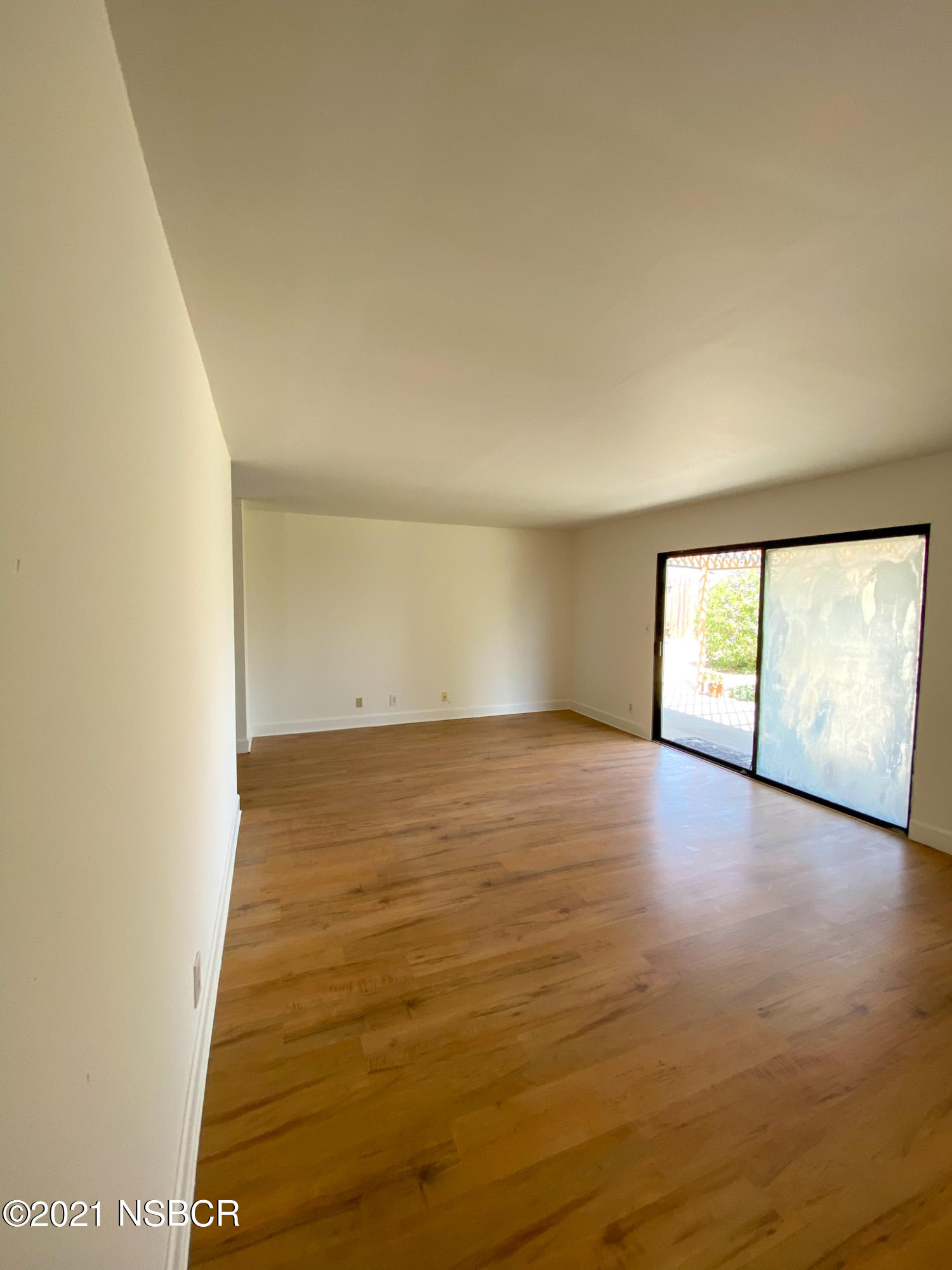 3941 Spica Way Lompoc, CA 93436 - Photo 10 of 24 an empty room with wooden floor and windows