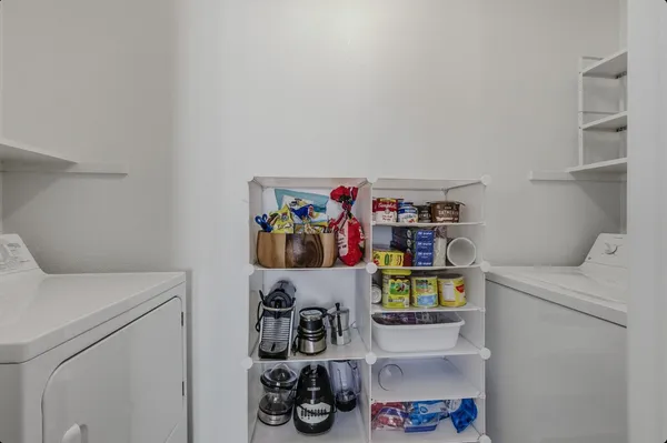 a room with a refrigerator and a bed