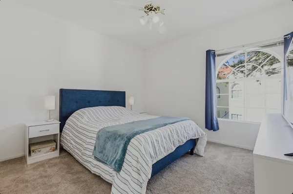 a bedroom with a bed and a wall painting