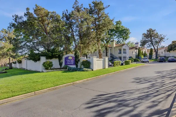 a front view of a house with a yard and road