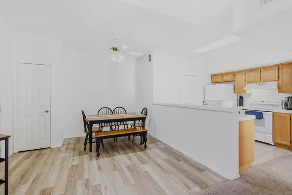 a view of a workspace with furniture and wooden floor
