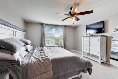 a bedroom with a large bed and flat tv