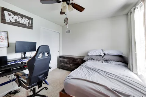 a bedroom with a bed and a desk