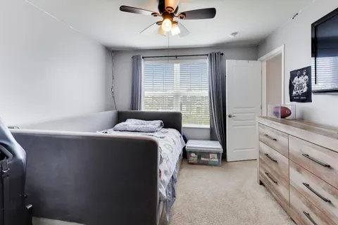 a bedroom with a bed and a dresser
