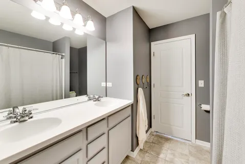 a bathroom with a sink vanity granite and a mirror