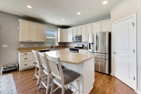 a kitchen with stainless steel appliances a refrigerator stove microwave and cabinets