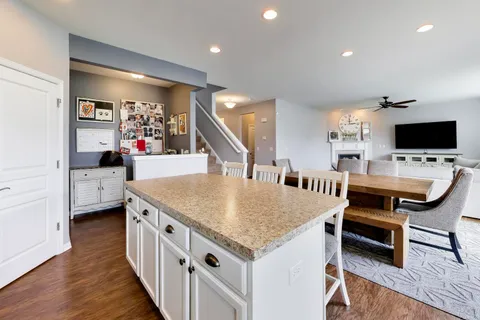 a dining room with furniture and a flat screen tv