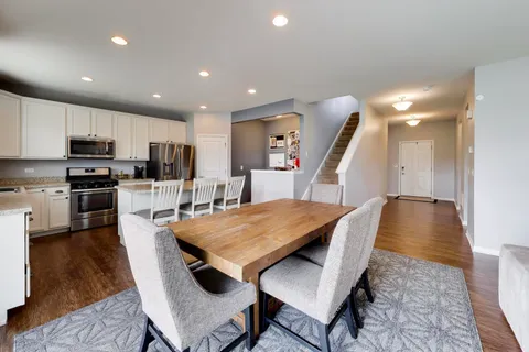 a large kitchen with kitchen island a table and chairs
