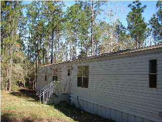 6238 Old River Road Baker, FL 32531 - Photo 2 of 8 a view of a house with a yard