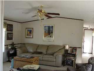 6238 Old River Road Baker, FL 32531 - Photo 4 of 8 a living room with furniture and a chandelier