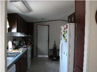 6238 Old River Road Baker, FL 32531 - Photo 5 of 8 a kitchen with stainless steel appliances granite countertop a refrigerator and a sink