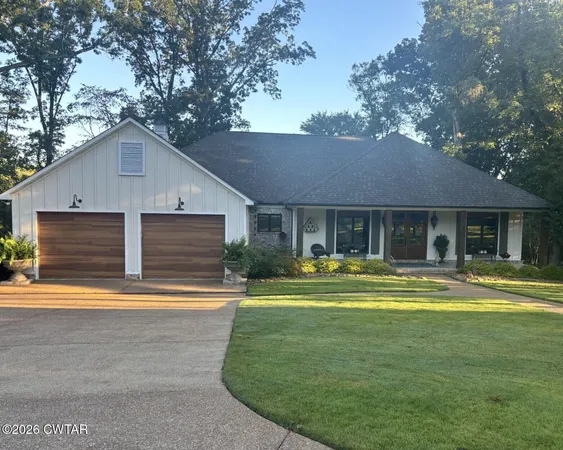 a front view of a house with a yard table and chairs