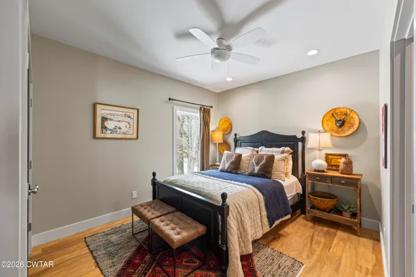 a view of a hallway with wooden floor and stairs