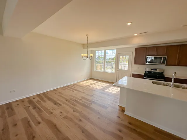 a view of a kitchen with microwave and windows