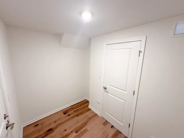 a view of room with wooden floor