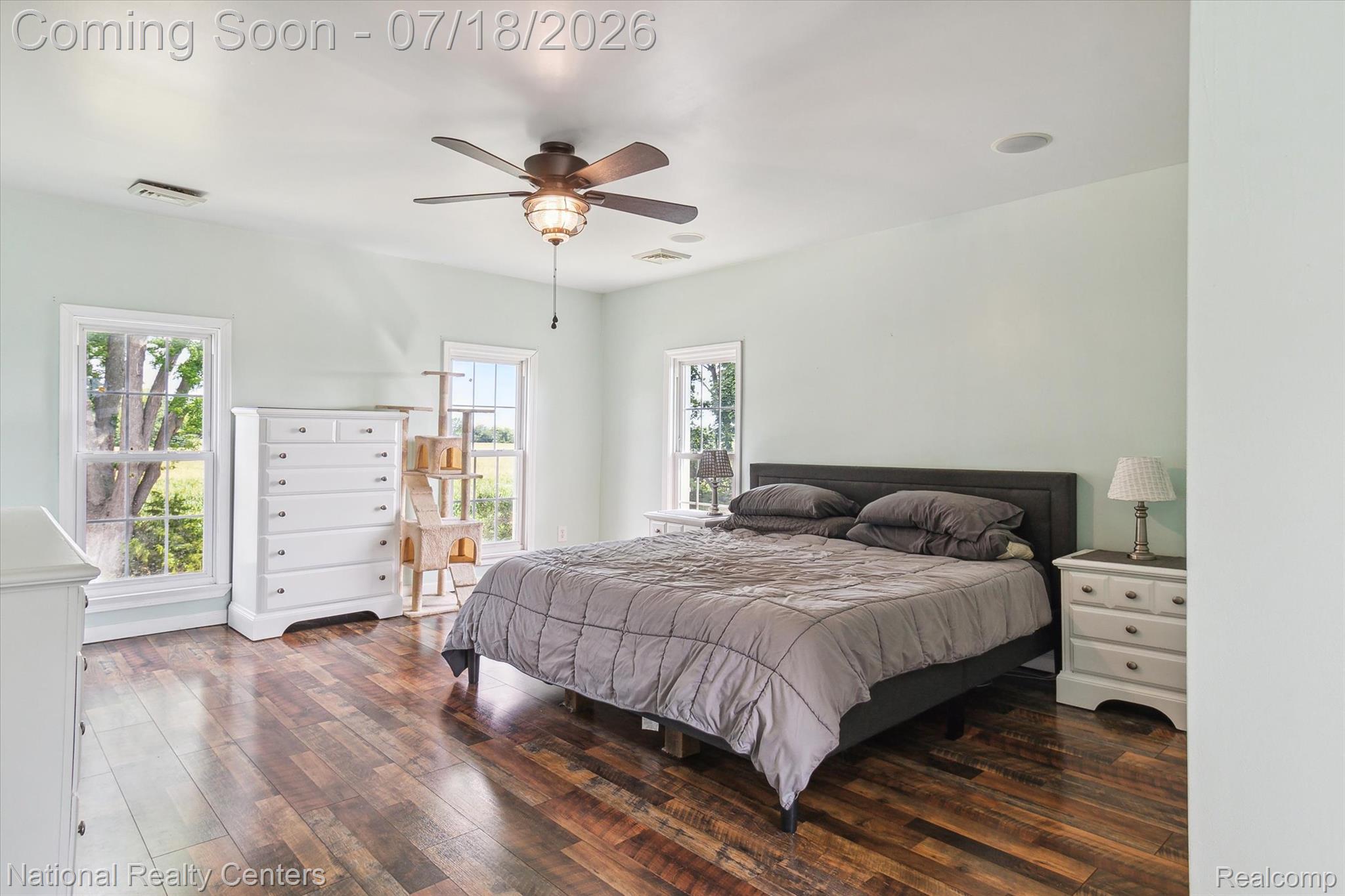 9589 Clinton Macon Road Tecumseh, MI 49286 - Photo 32 of 48 Spacious room featuring wood-finish flooring, light-colored walls, and a ceiling fan with integrated lighting