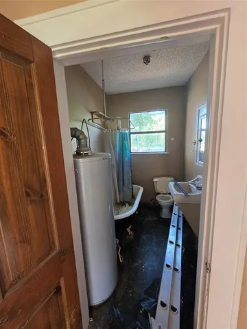 a view of a room with furniture and a window