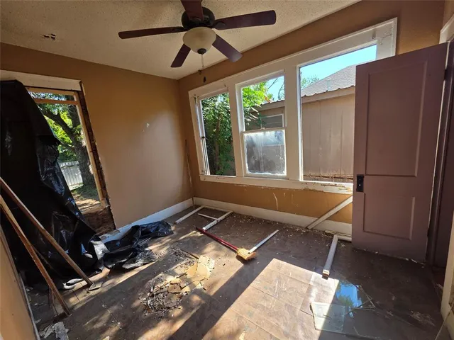 a living room with a bed furniture and a window