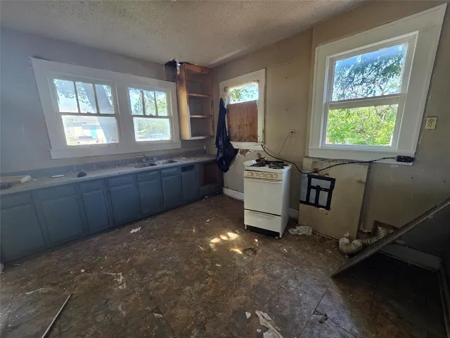 a room with painting on the wall and a window