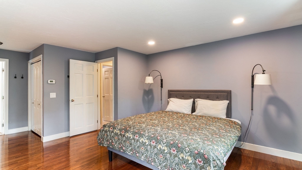 142 Baker Street Walpole, MA 02081 - Photo 29 of 42 a bedroom with a bed and wooden floor