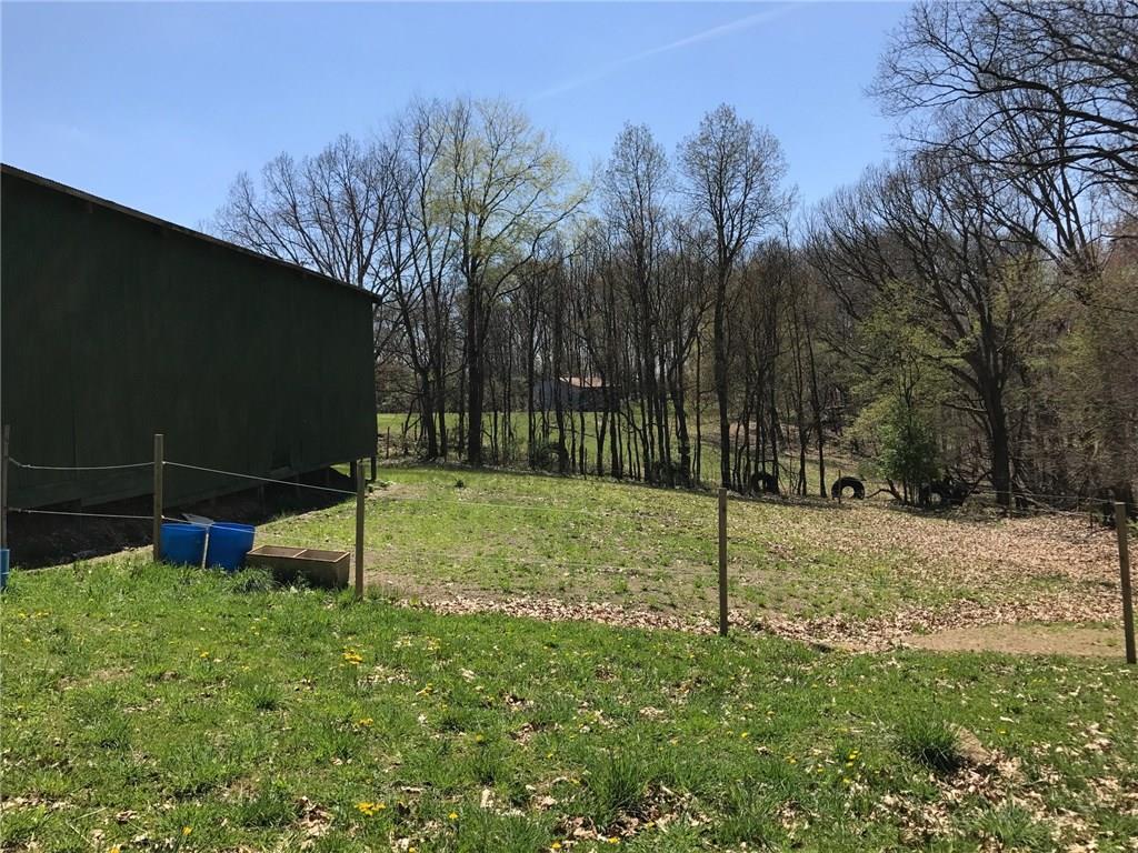3600 Centerview Road Gibsonia, PA 15044 - Photo 18 of 25 Fenced area between the large barn and the hay barn. See that other barn off in the distance? That field is through the end door of the big barn.
