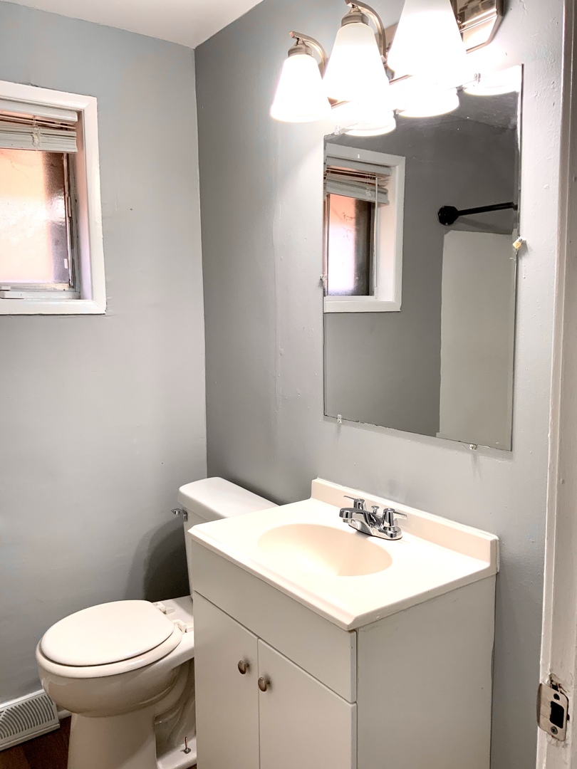 11634 South May Street Chicago, IL 60643 - Photo 3 of 9 a bathroom with a sink mirror and toilet