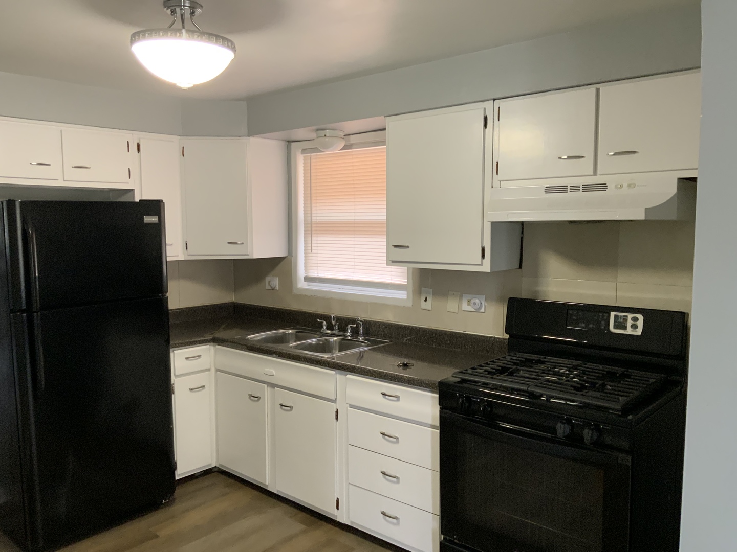 11634 South May Street Chicago, IL 60643 - Photo 7 of 9 a kitchen with granite countertop white cabinets and black appliances