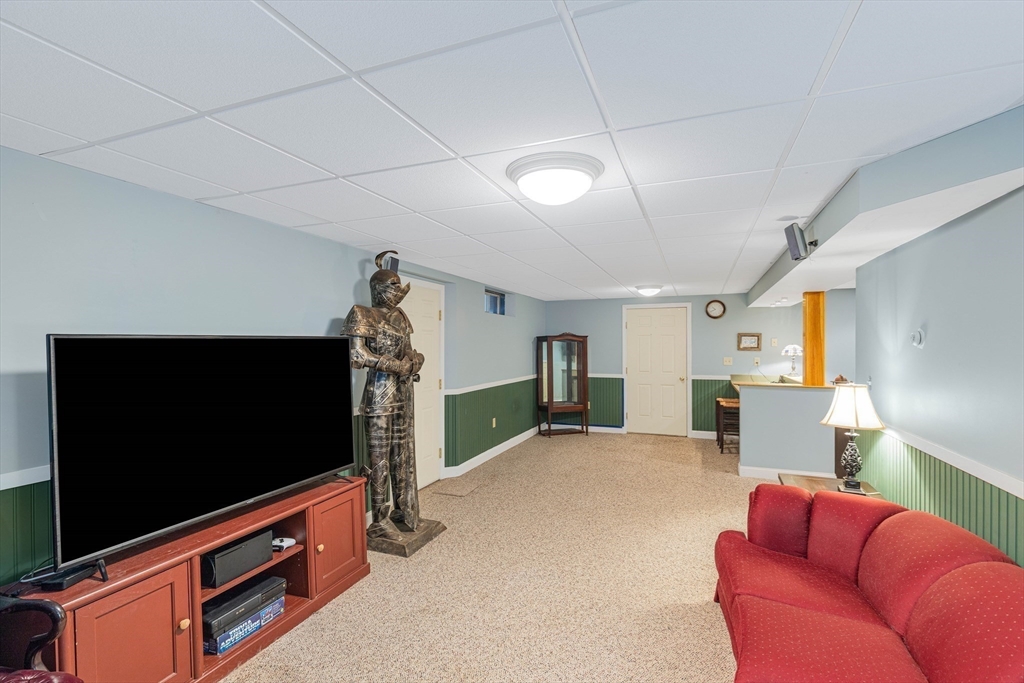 54 Old Merrill Street Amesbury, MA 01913 - Photo 29 of 34 a living room with furniture and a flat screen tv
