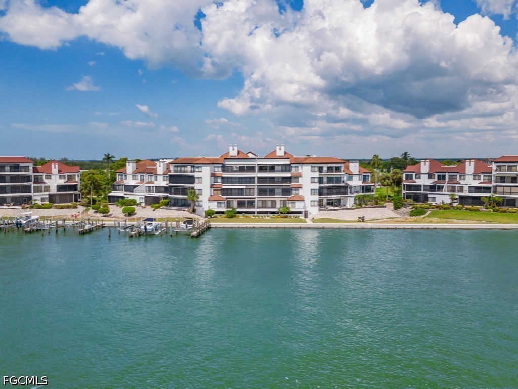 232 La Peninsula Boulevard, Unit 232 Naples, FL 34113 - Photo 30 of 44 a view of a city with tall buildings