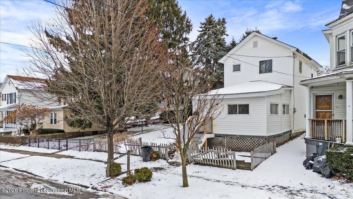 a front view of a house with yard and seating