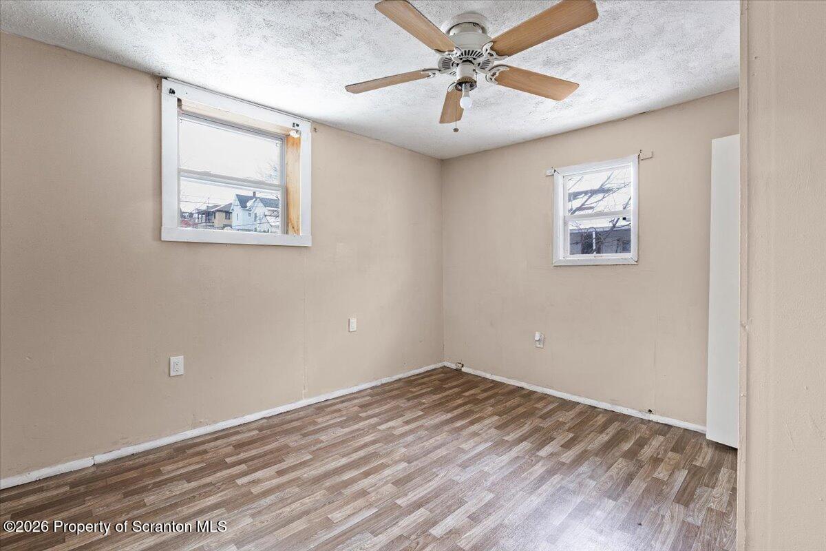 719 South Webster Avenue Scranton, PA 18505 - Photo 11 of 17 an empty room with a window and a ceiling fan