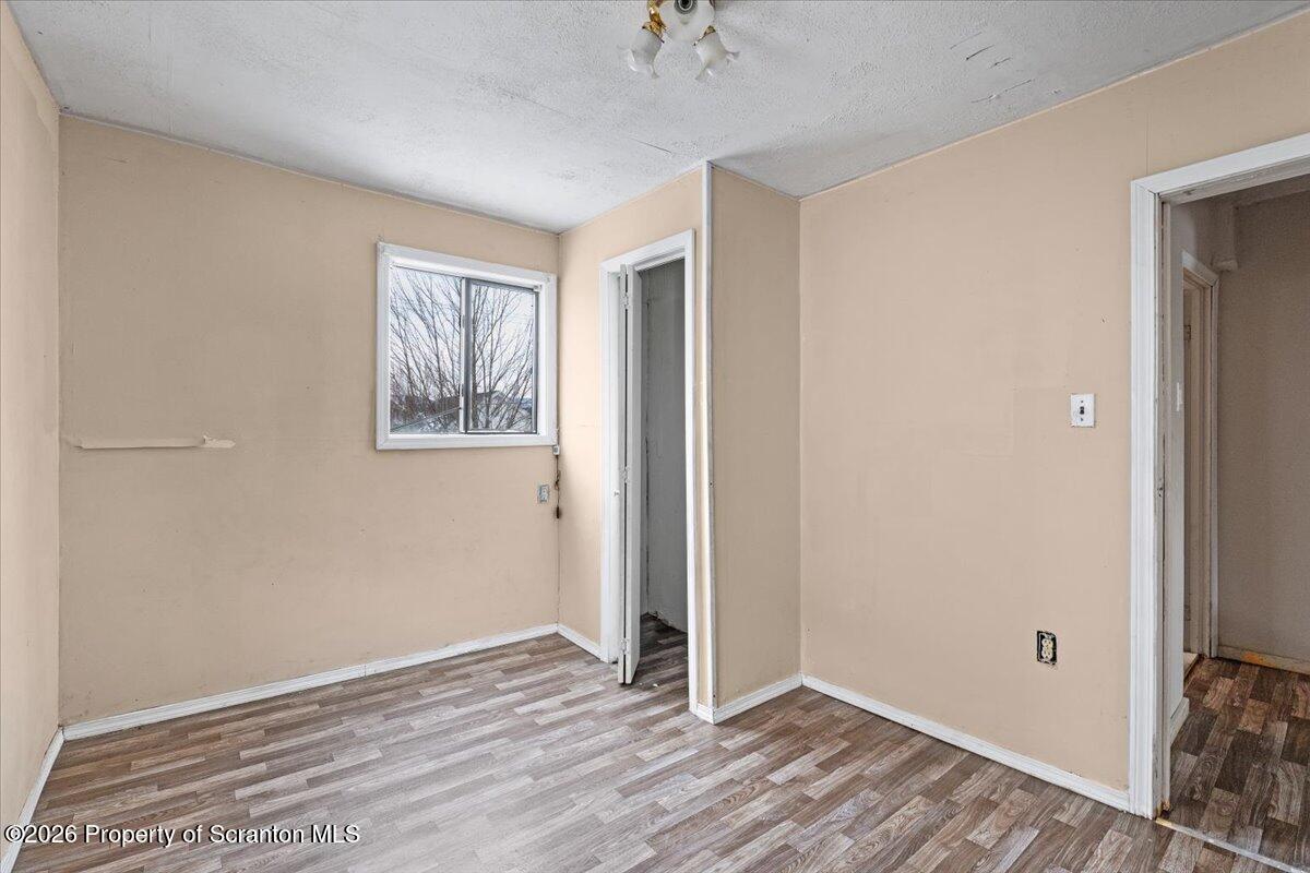 719 South Webster Avenue Scranton, PA 18505 - Photo 13 of 17 a view of an empty room with wooden floor and a window