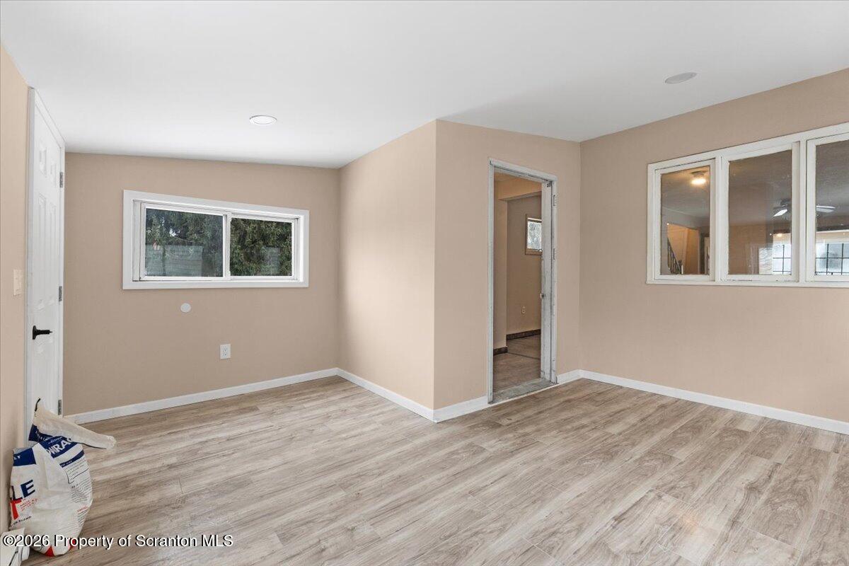 719 South Webster Avenue Scranton, PA 18505 - Photo 2 of 17 a view of an empty room with wooden floor and a window