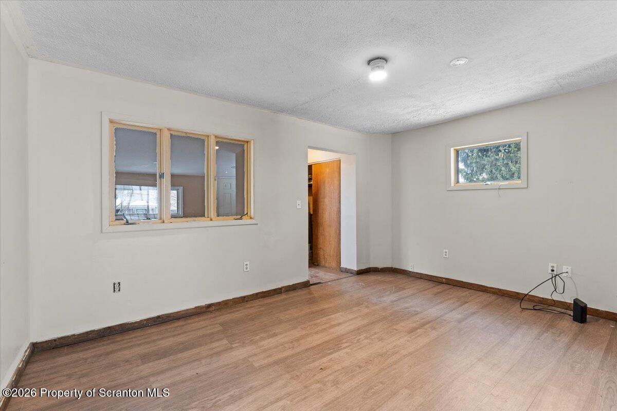 719 South Webster Avenue Scranton, PA 18505 - Photo 3 of 17 a view of an empty room with a window and wooden floor