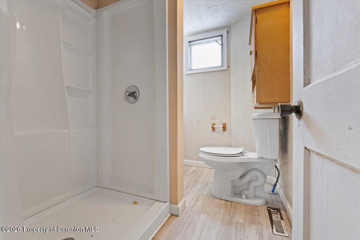 719 South Webster Avenue Scranton, PA 18505 - Photo 10 of 17 a bathroom with a toilet a sink and mirror