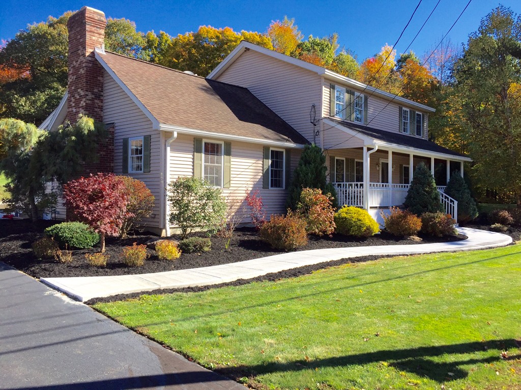 a front view of house with yard and outdoor seating