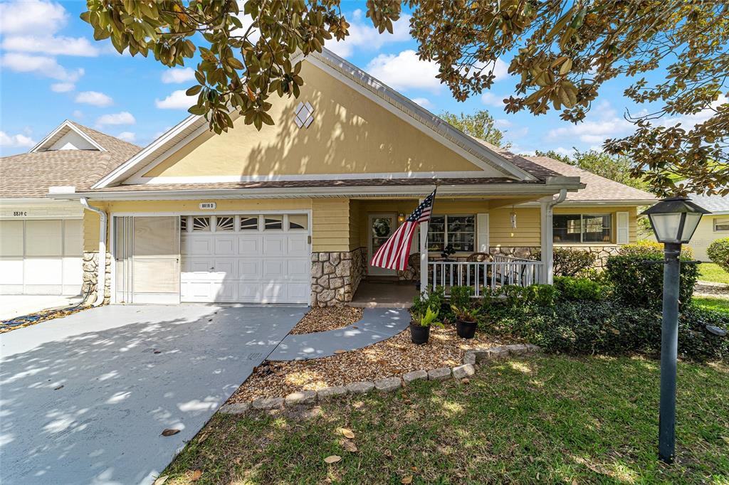 8819 Southwest 91st Place, Unit D Ocala, FL 34481 - Photo 1 of 1 a front view of a house with garden
