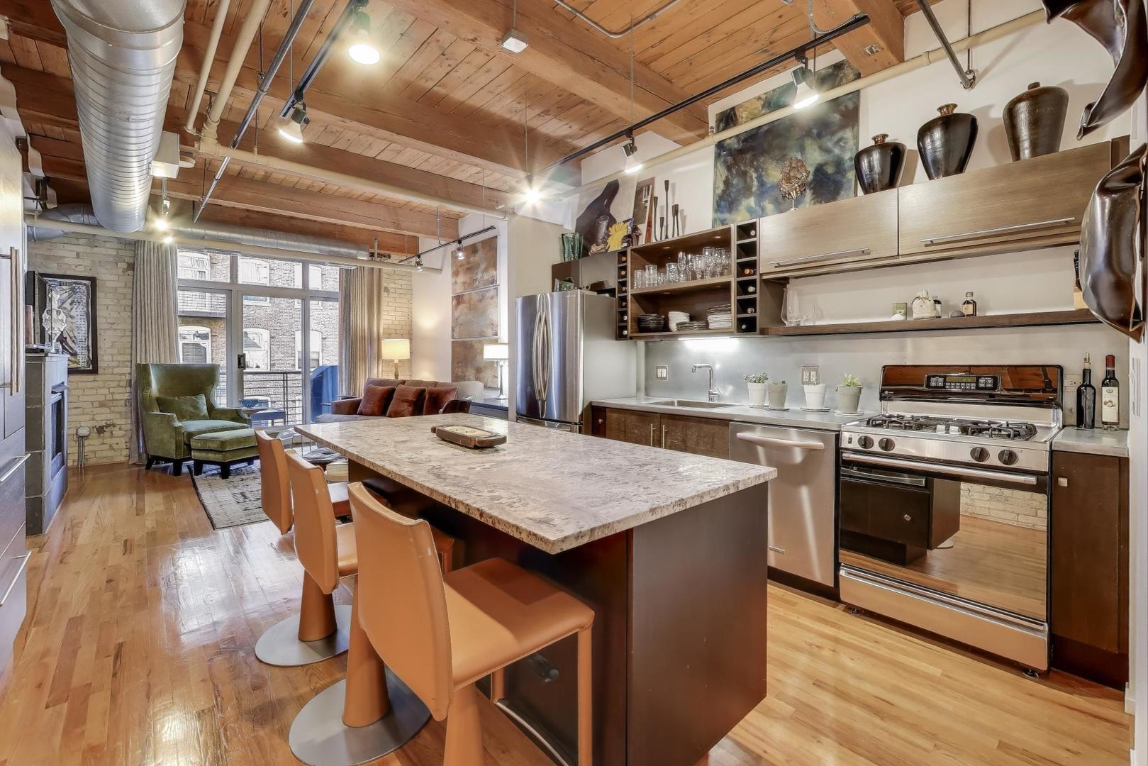 420 South Clinton Street, Unit 414A Chicago, IL 60607 - Photo 3 of 13 a kitchen with stainless steel appliances granite countertop a stove and a refrigerator