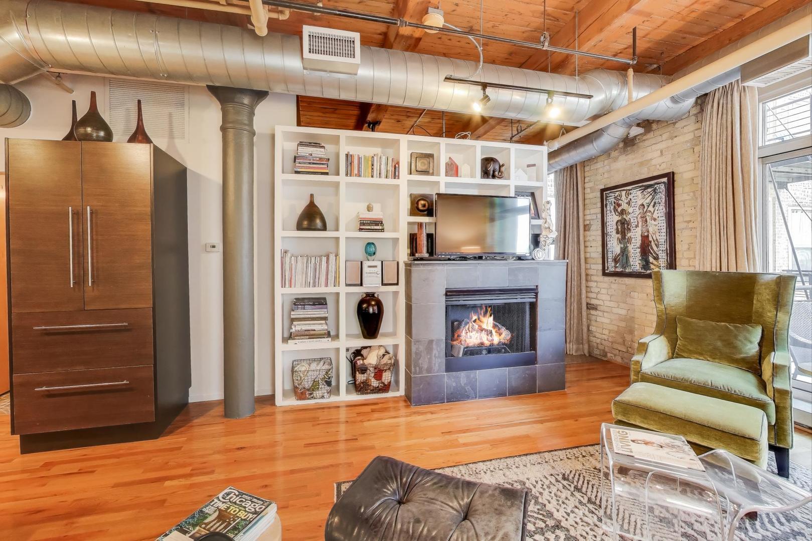 420 South Clinton Street, Unit 414A Chicago, IL 60607 - Photo 7 of 13 a living room with furniture and a fireplace