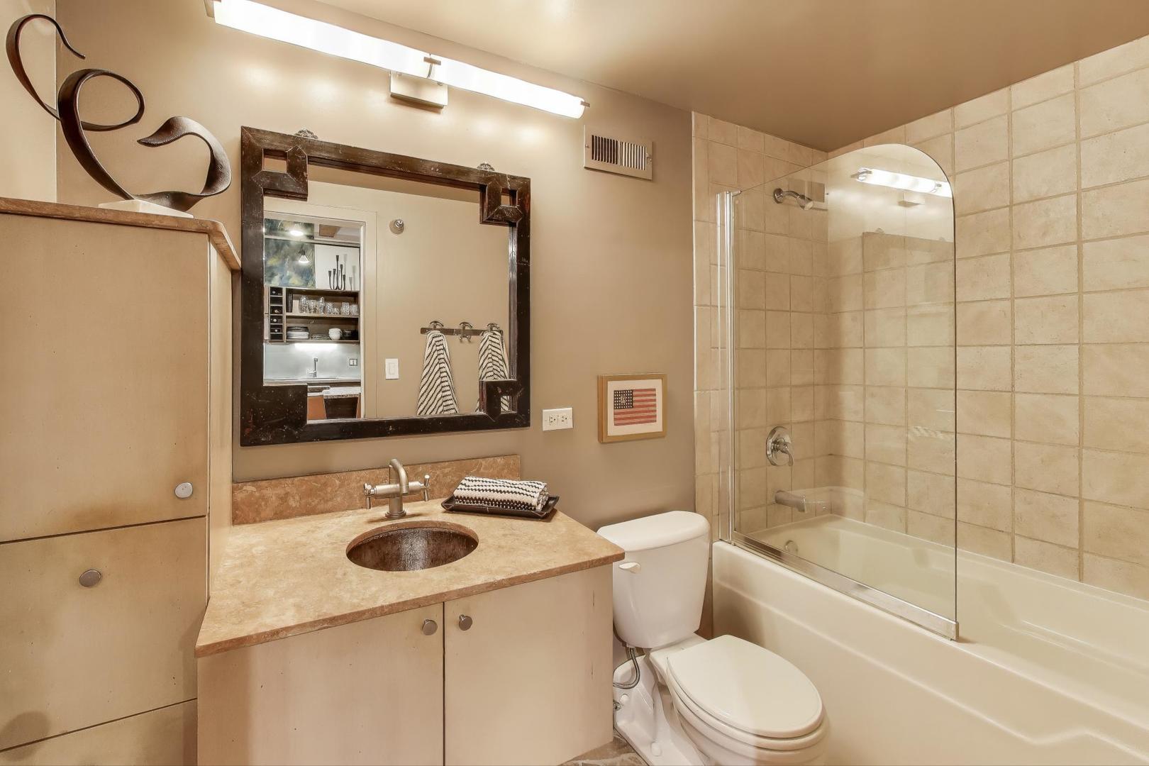 420 South Clinton Street, Unit 414A Chicago, IL 60607 - Photo 10 of 13 a bathroom with a sink toilet and shower